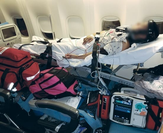 A patient on a commercial stretcher Flight